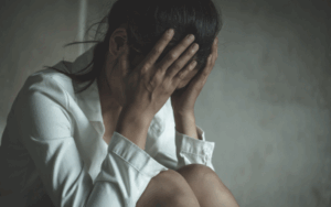 woman upset with her head in her hands