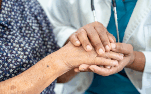 carer holding elderly's hand